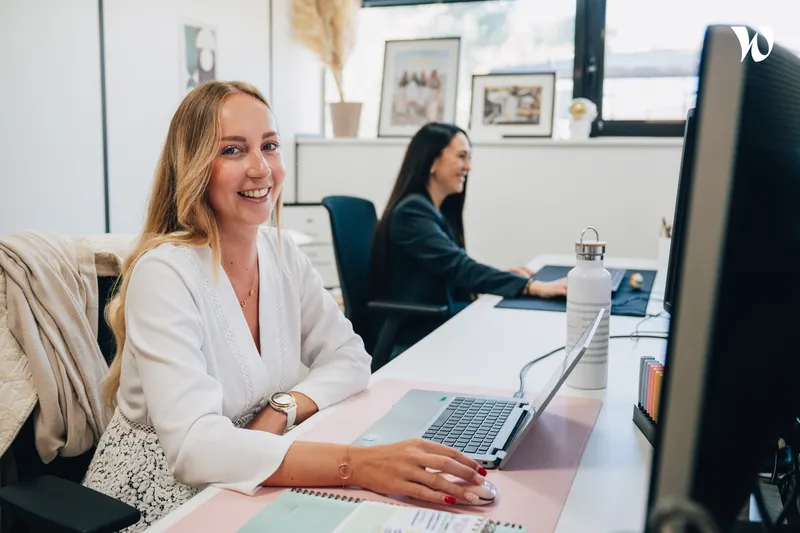 jeune femme souriante assise à son bureau <p>jeune femme souriante assise à son bureau</p>