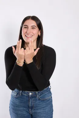 a woman smiling with her hands up